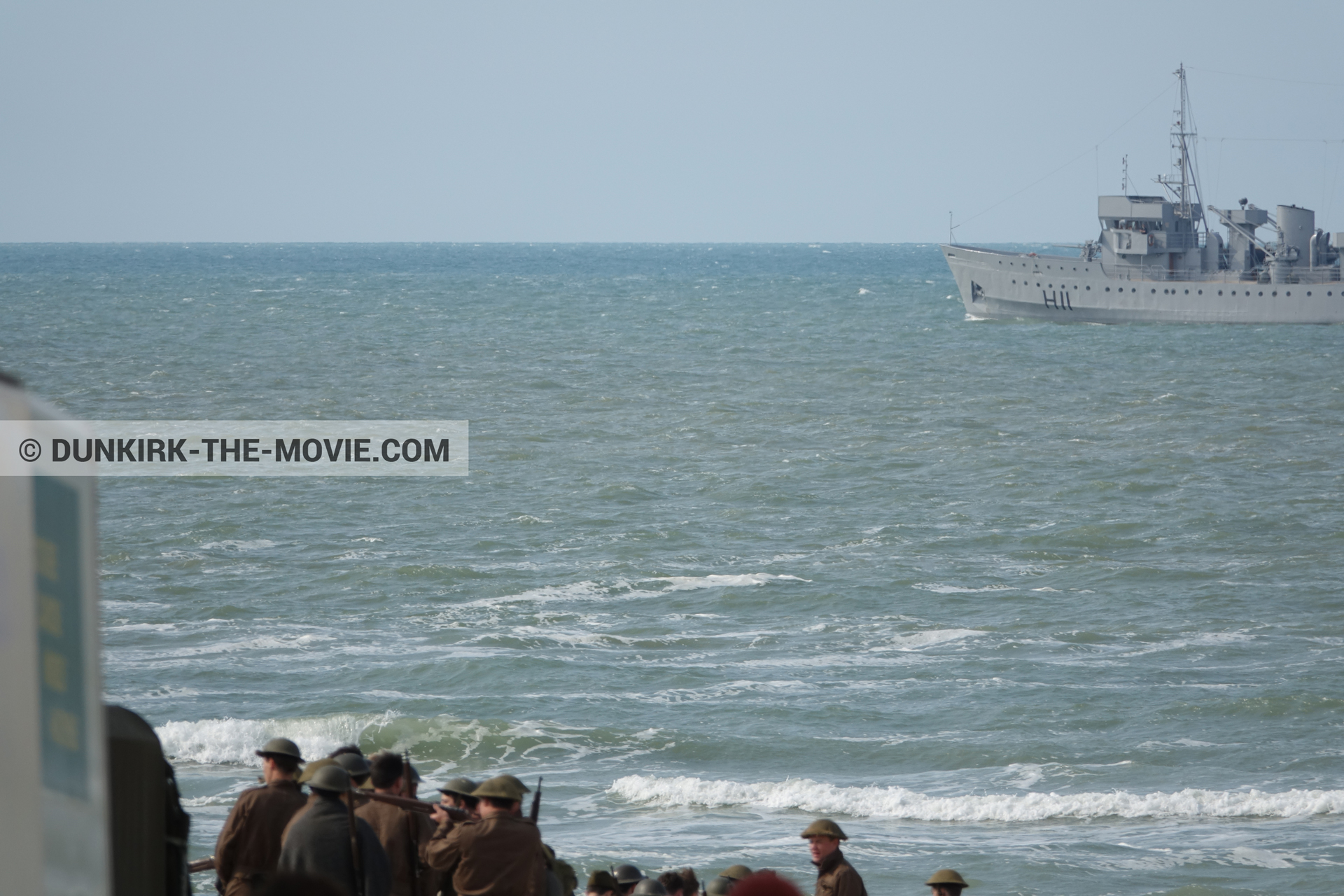 Picture with boat, supernumeraries, rough sea,  from behind the scene of the Dunkirk movie by Nolan