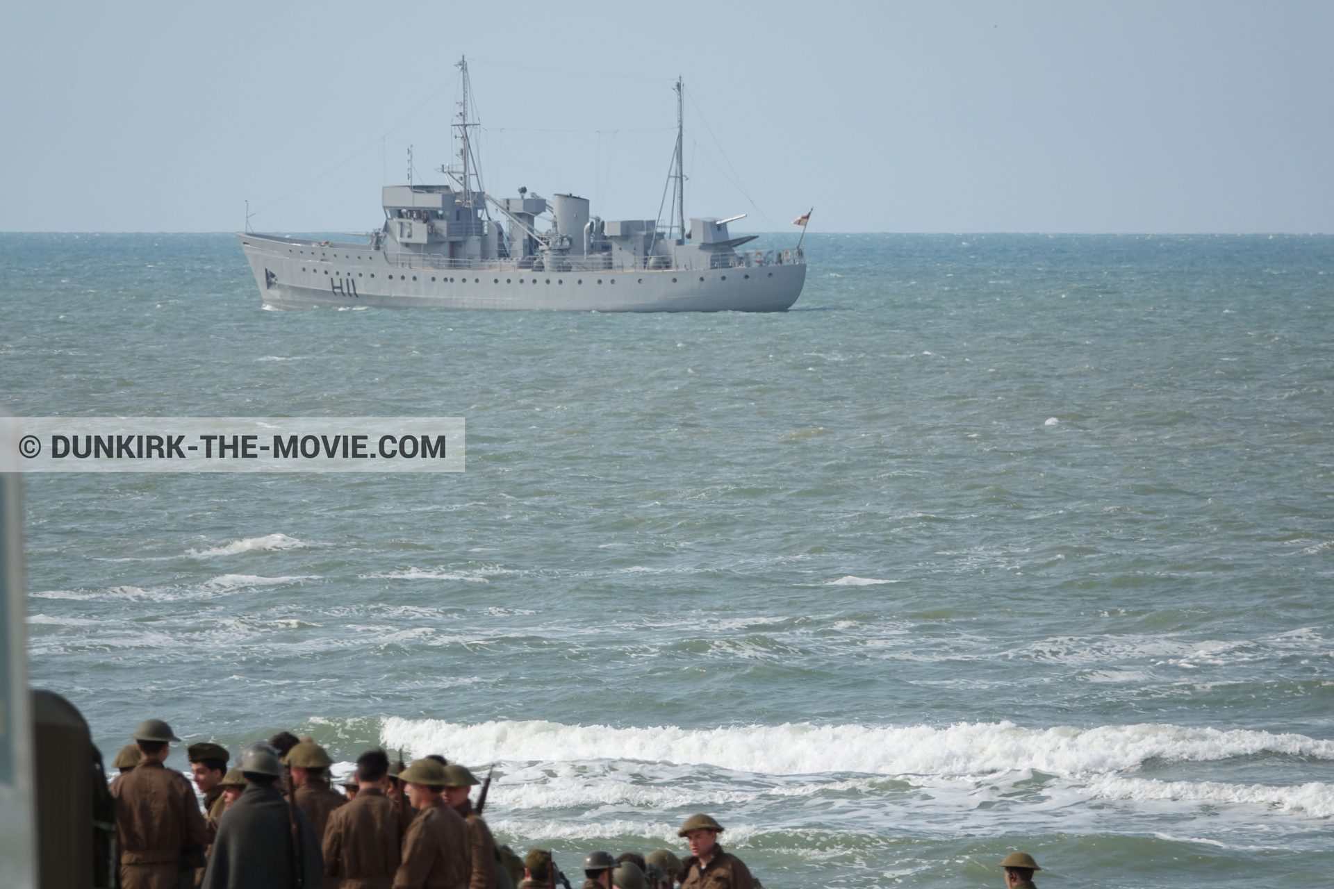 Picture with boat, supernumeraries, rough sea,  from behind the scene of the Dunkirk movie by Nolan