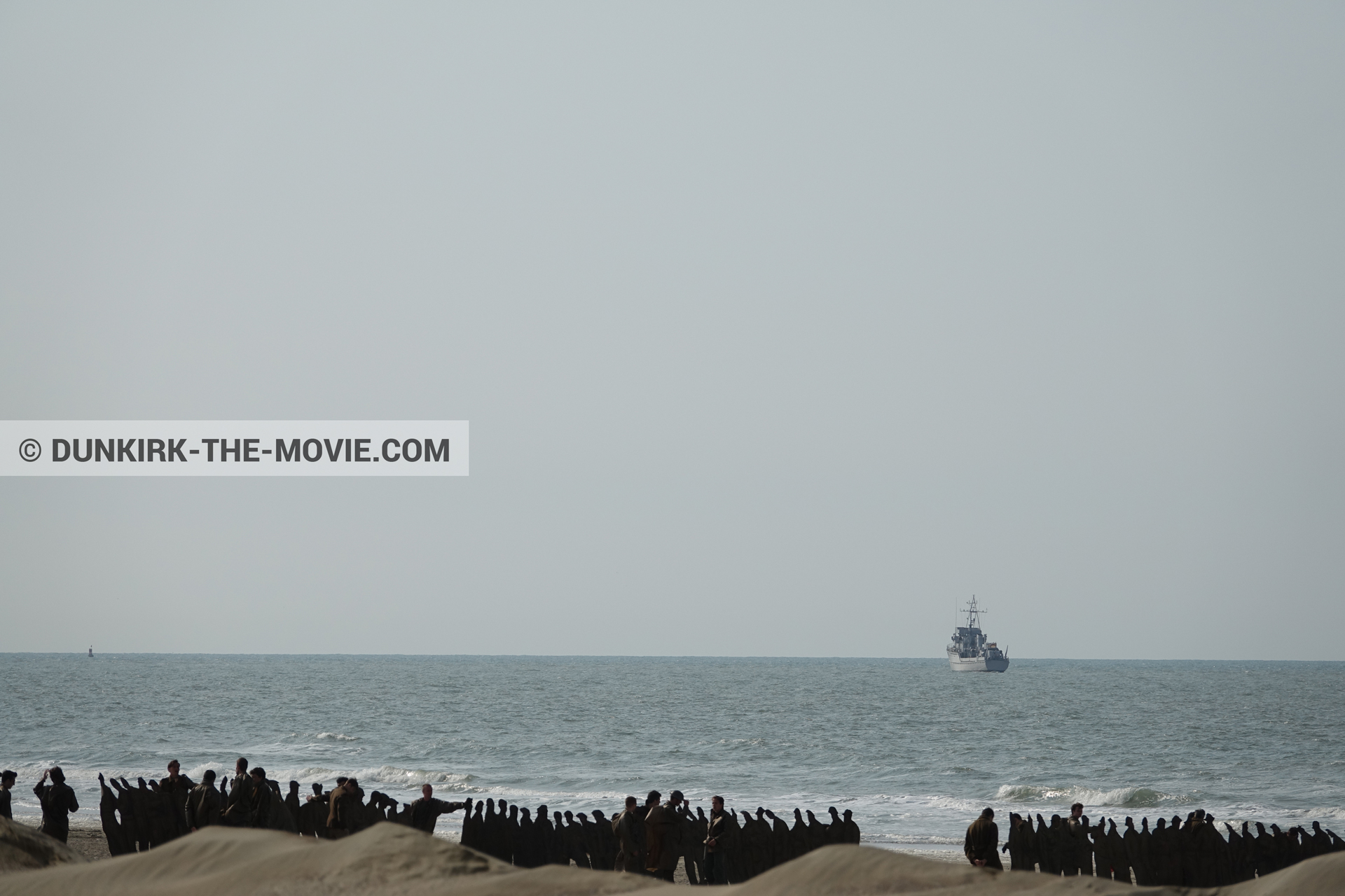 Picture with boat, decor, supernumeraries, rough sea, beach,  from behind the scene of the Dunkirk movie by Nolan