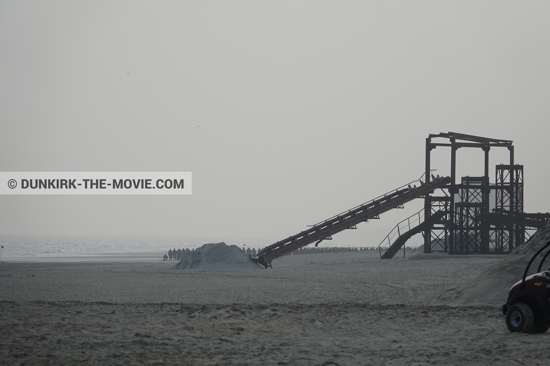 Picture with grey sky, decor, supernumeraries, beach,  from behind the scene of the Dunkirk movie by Nolan