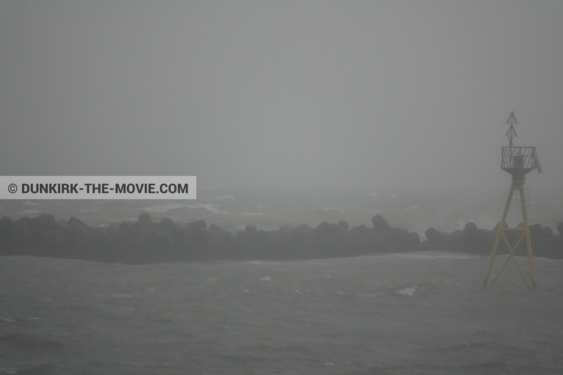Picture with grey sky, EST pier, rough sea,  from behind the scene of the Dunkirk movie by Nolan