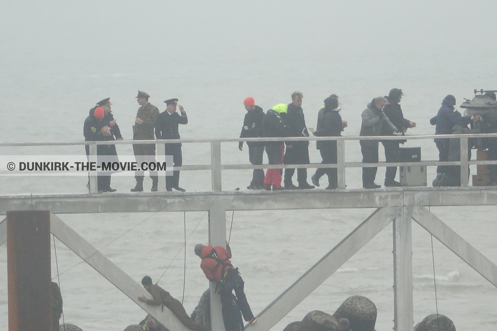 Picture with actor, grey sky, EST pier, Christopher Nolan, technical team,  from behind the scene of the Dunkirk movie by Nolan