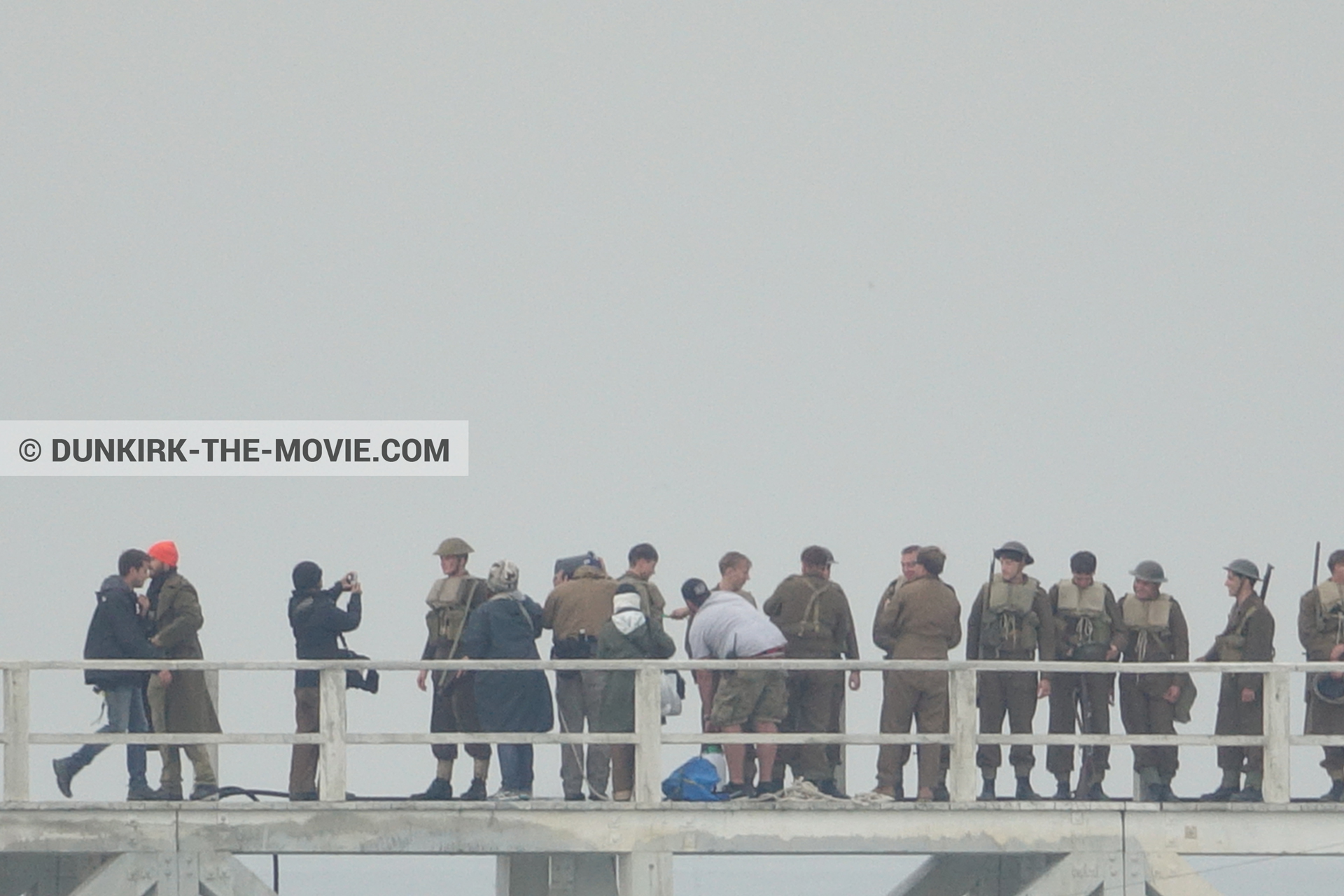 Picture with grey sky, supernumeraries, EST pier, technical team,  from behind the scene of the Dunkirk movie by Nolan