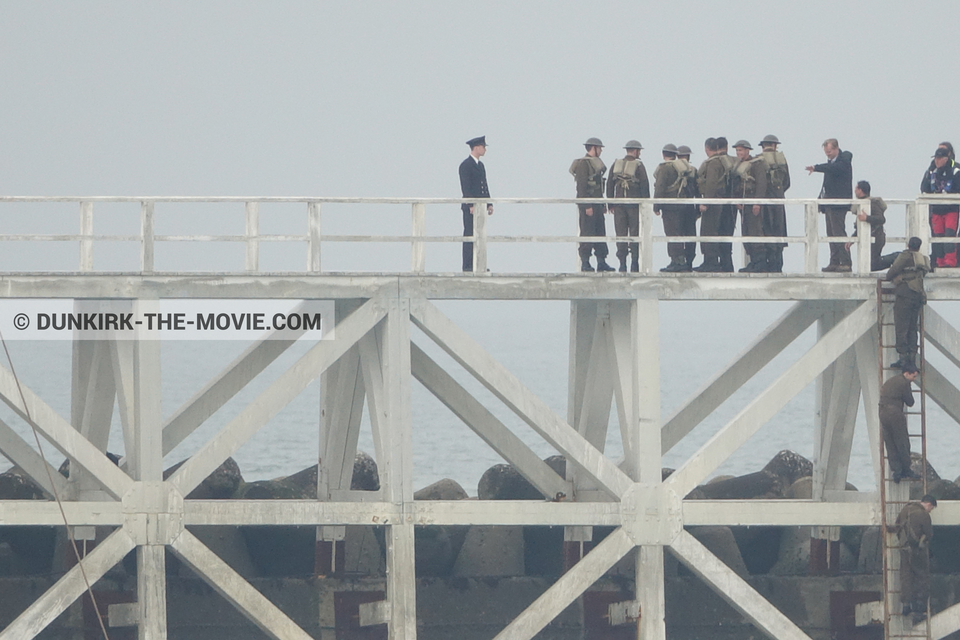 Picture with actor, grey sky, supernumeraries, EST pier, Christopher Nolan, technical team,  from behind the scene of the Dunkirk movie by Nolan