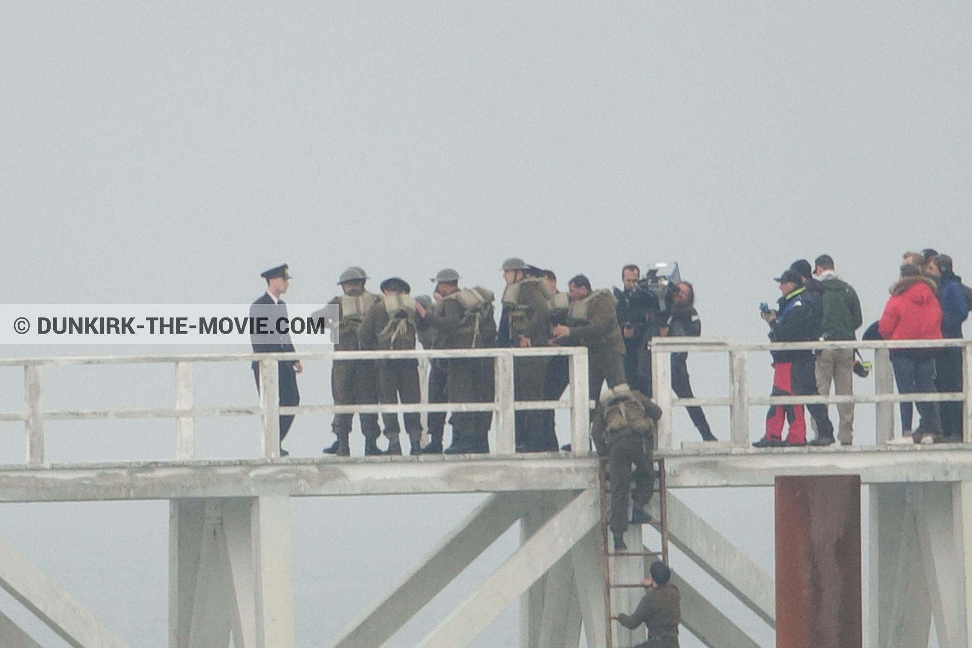 Picture with actor, IMAX camera, grey sky, supernumeraries, Hoyte van Hoytema, EST pier, technical team,  from behind the scene of the Dunkirk movie by Nolan