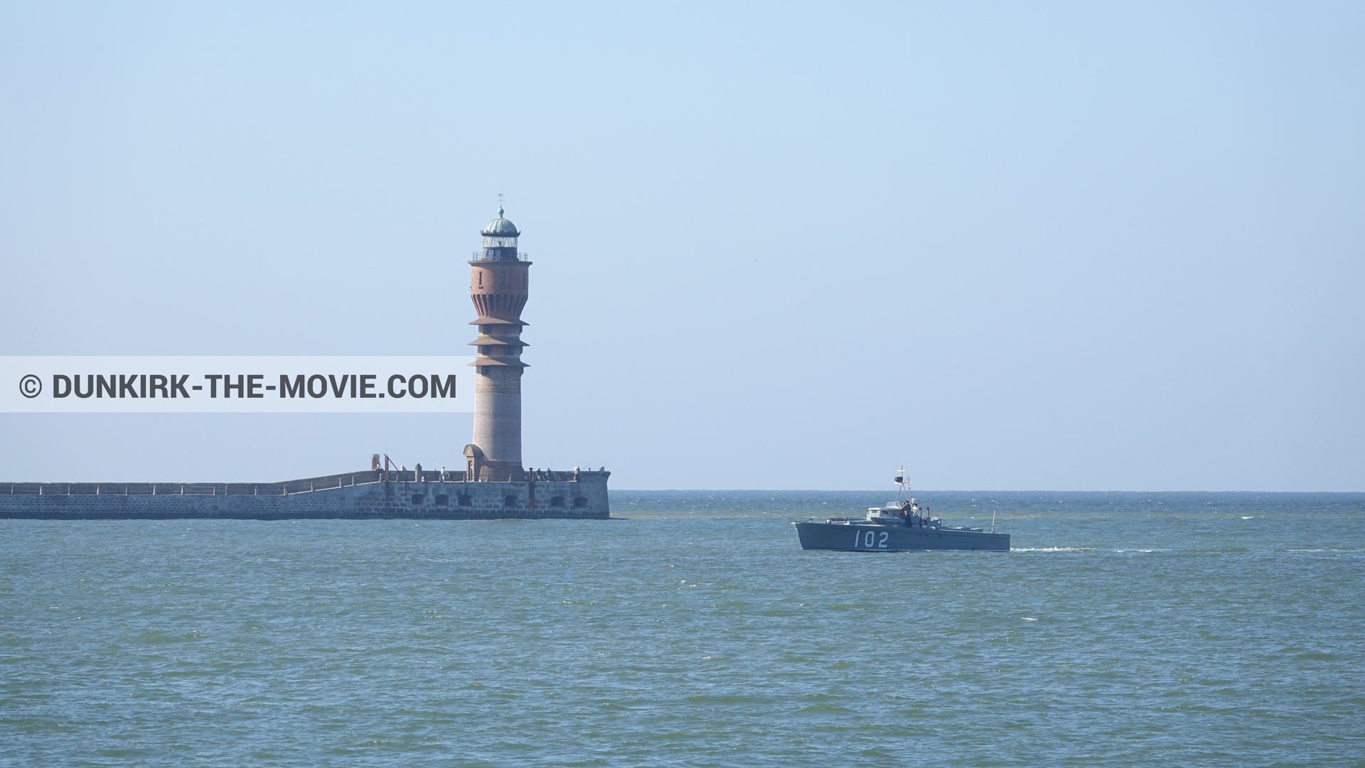 Picture with boat, blue sky, calm sea, St Pol sur Mer lighthouse,  from behind the scene of the Dunkirk movie by Nolan