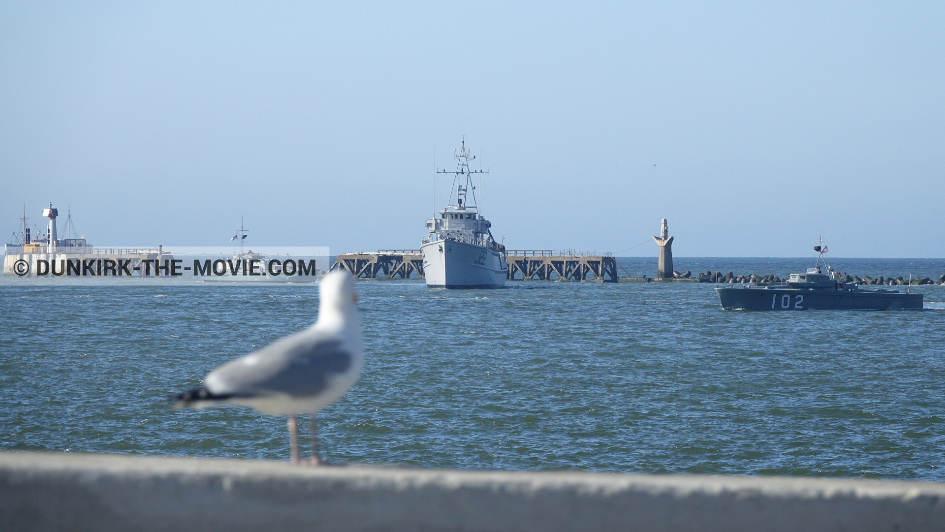 Picture with boat, blue sky, calm sea,  from behind the scene of the Dunkirk movie by Nolan