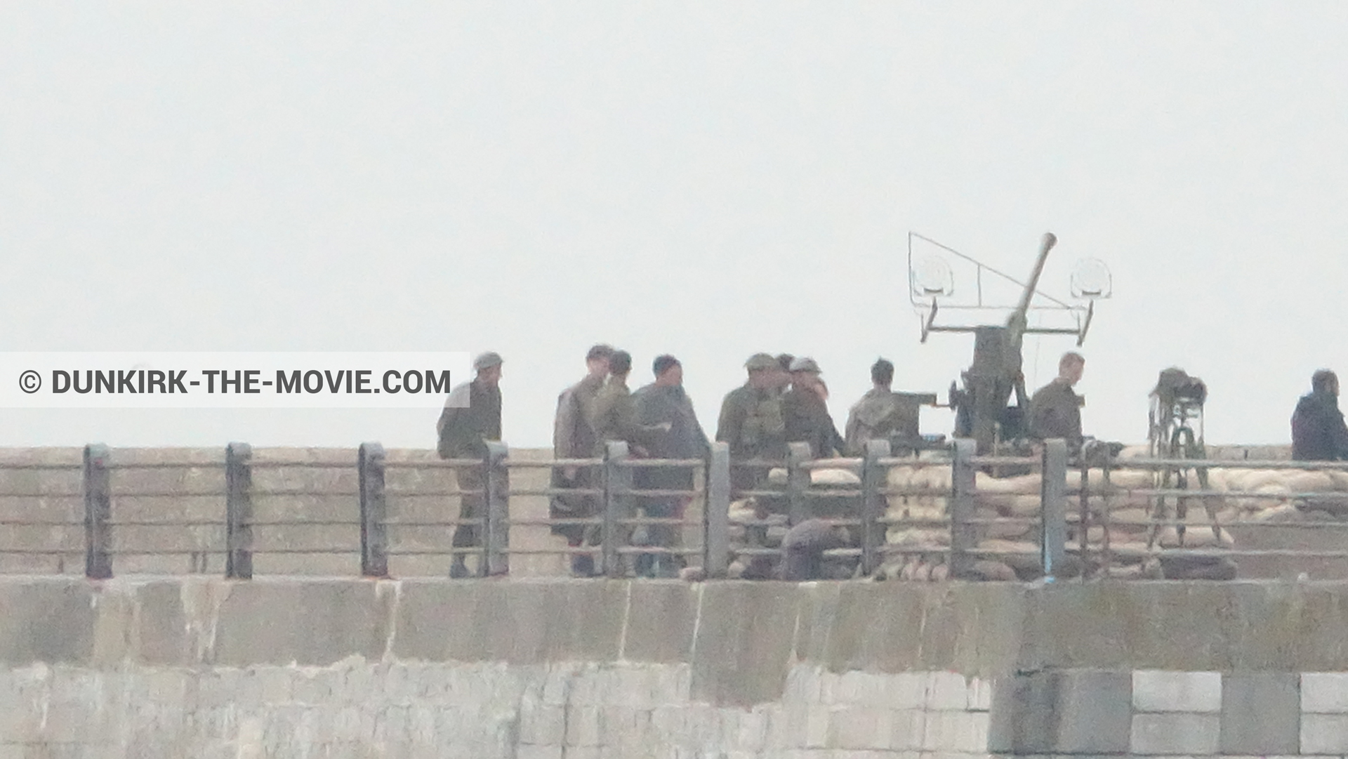 Picture with cannon, grey sky, supernumeraries, EST pier,  from behind the scene of the Dunkirk movie by Nolan