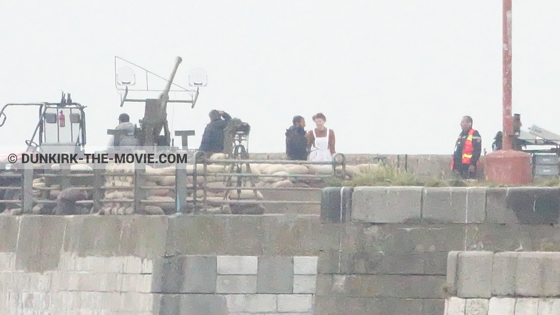 Fotos con cañón, cielo gris, extras, muelle del ESTE, equipo técnica,  durante el rodaje de la película Dunkerque de Nolan