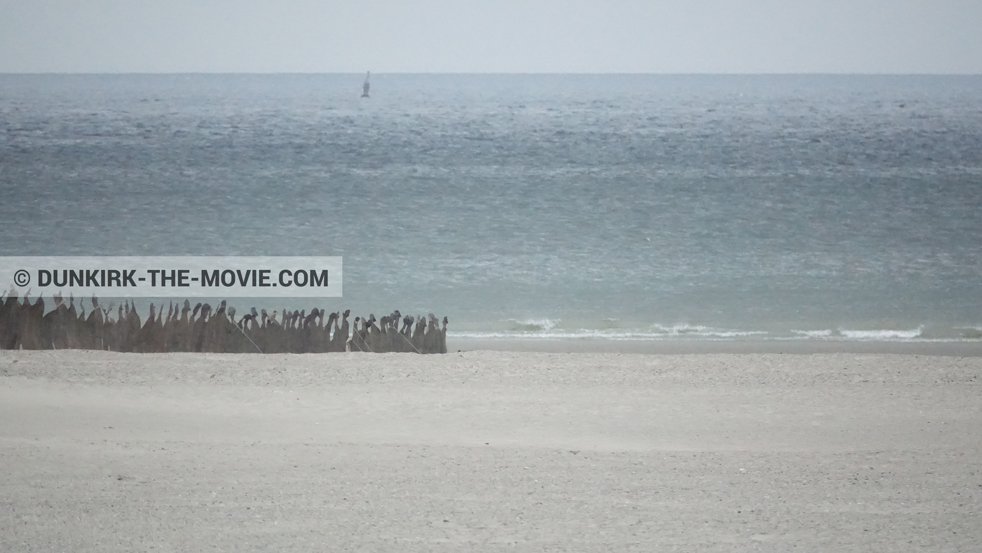 Picture with grey sky, decor, beach,  from behind the scene of the Dunkirk movie by Nolan