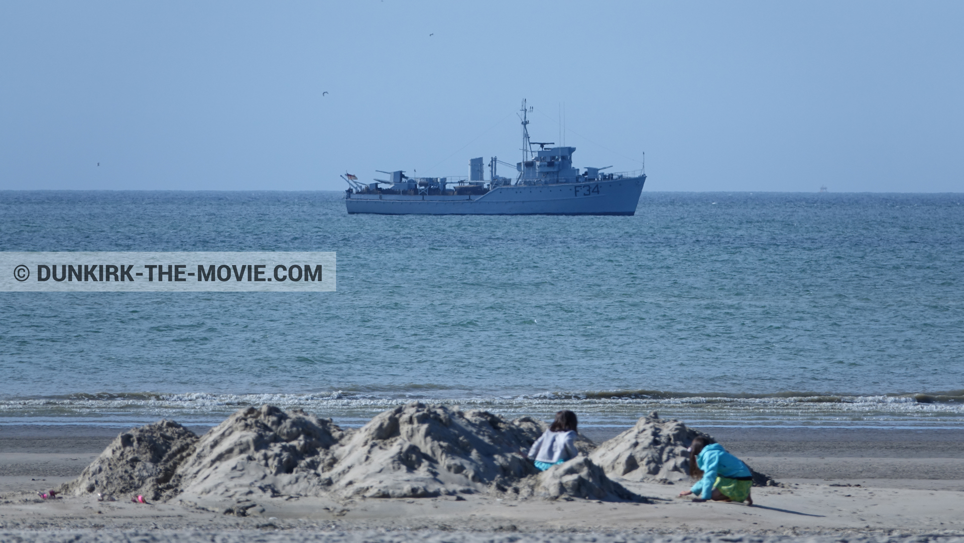 Picture with blue sky, F34 - Hr.Ms. Sittard, calm sea, beach,  from behind the scene of the Dunkirk movie by Nolan