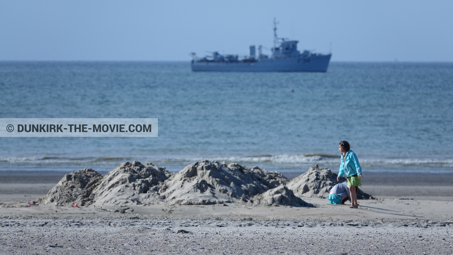 Picture with blue sky, F34 - Hr.Ms. Sittard, calm sea, beach,  from behind the scene of the Dunkirk movie by Nolan