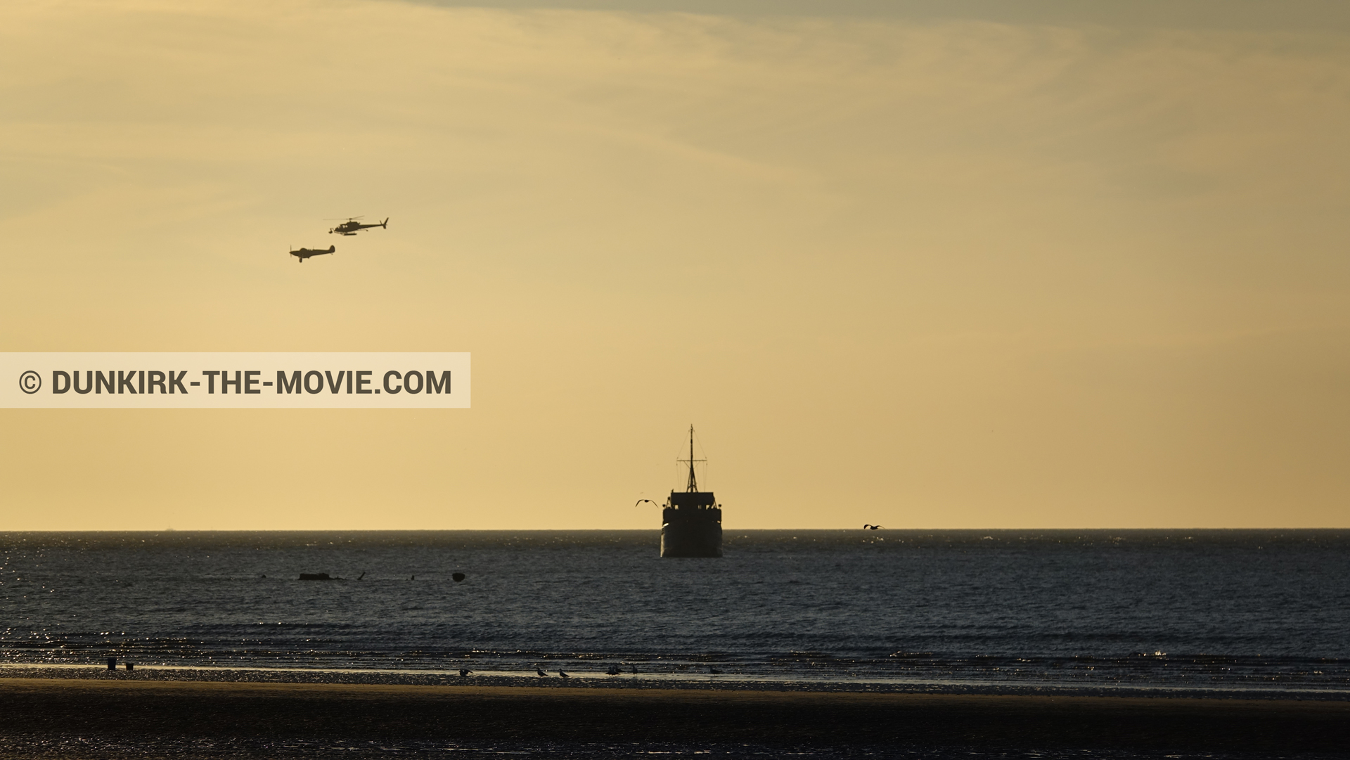 Picture with plane, boat, orange sky, helicopter camera,  from behind the scene of the Dunkirk movie by Nolan