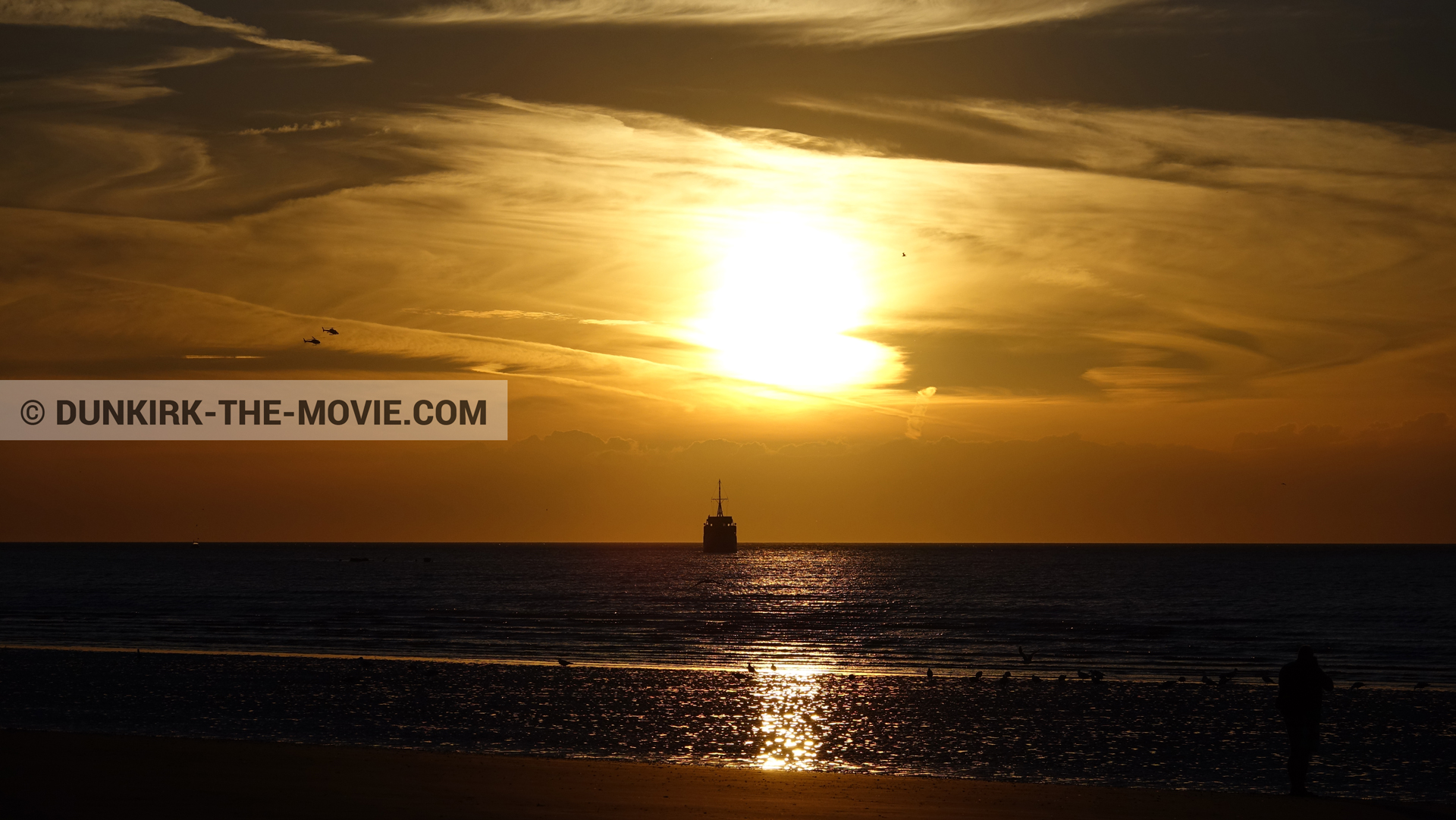 Picture with boat, orange sky,  from behind the scene of the Dunkirk movie by Nolan