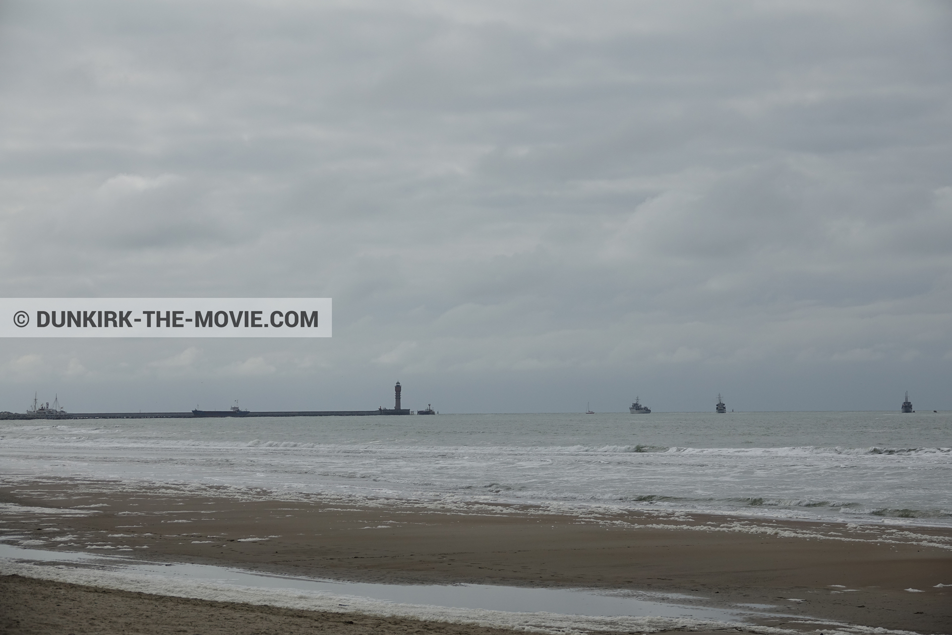Picture with boat, cloudy sky, Malo les Bains, St Pol sur Mer lighthouse, beach,  from behind the scene of the Dunkirk movie by Nolan