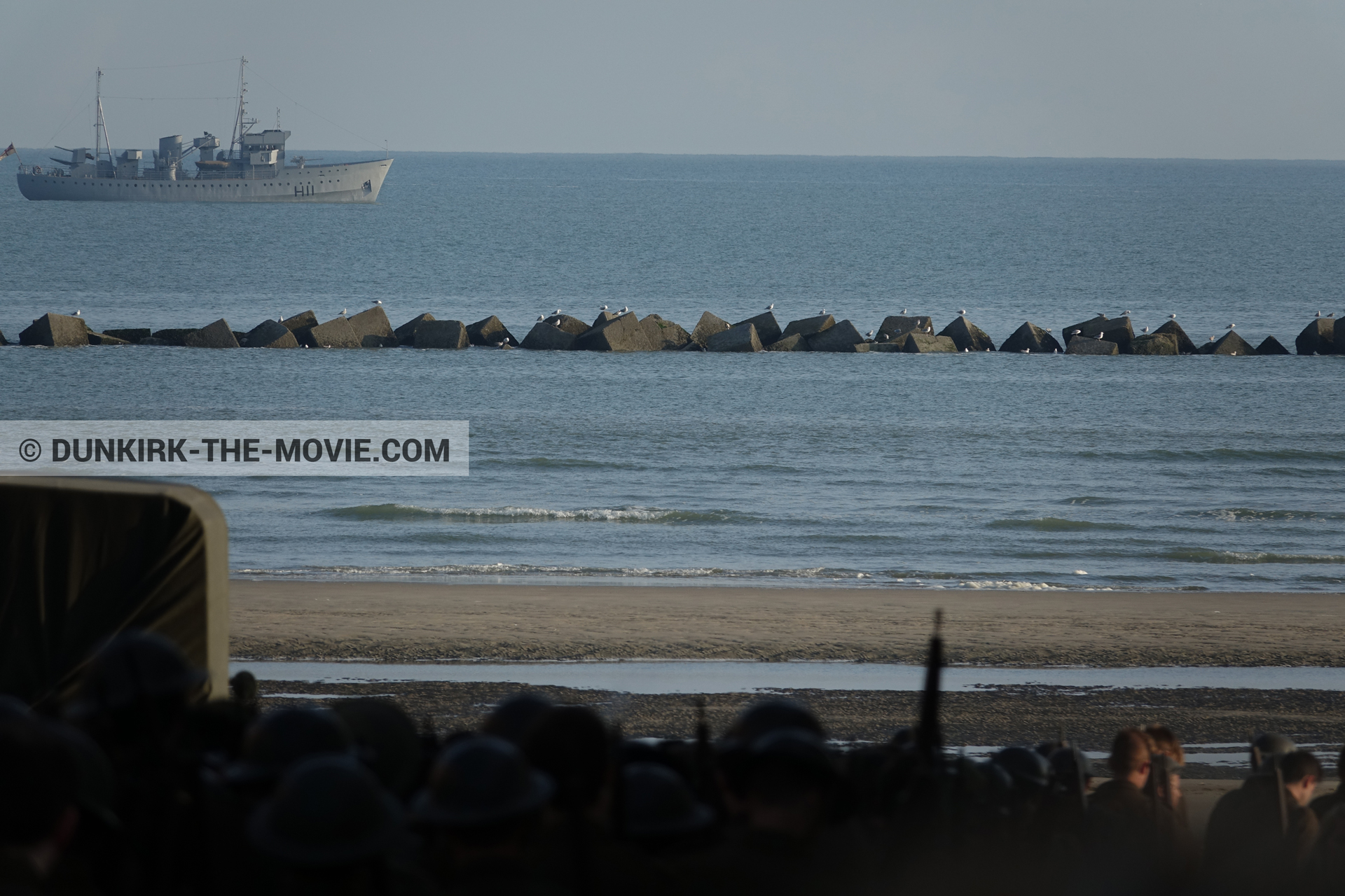 Picture with boat, truck, supernumeraries, beach,  from behind the scene of the Dunkirk movie by Nolan