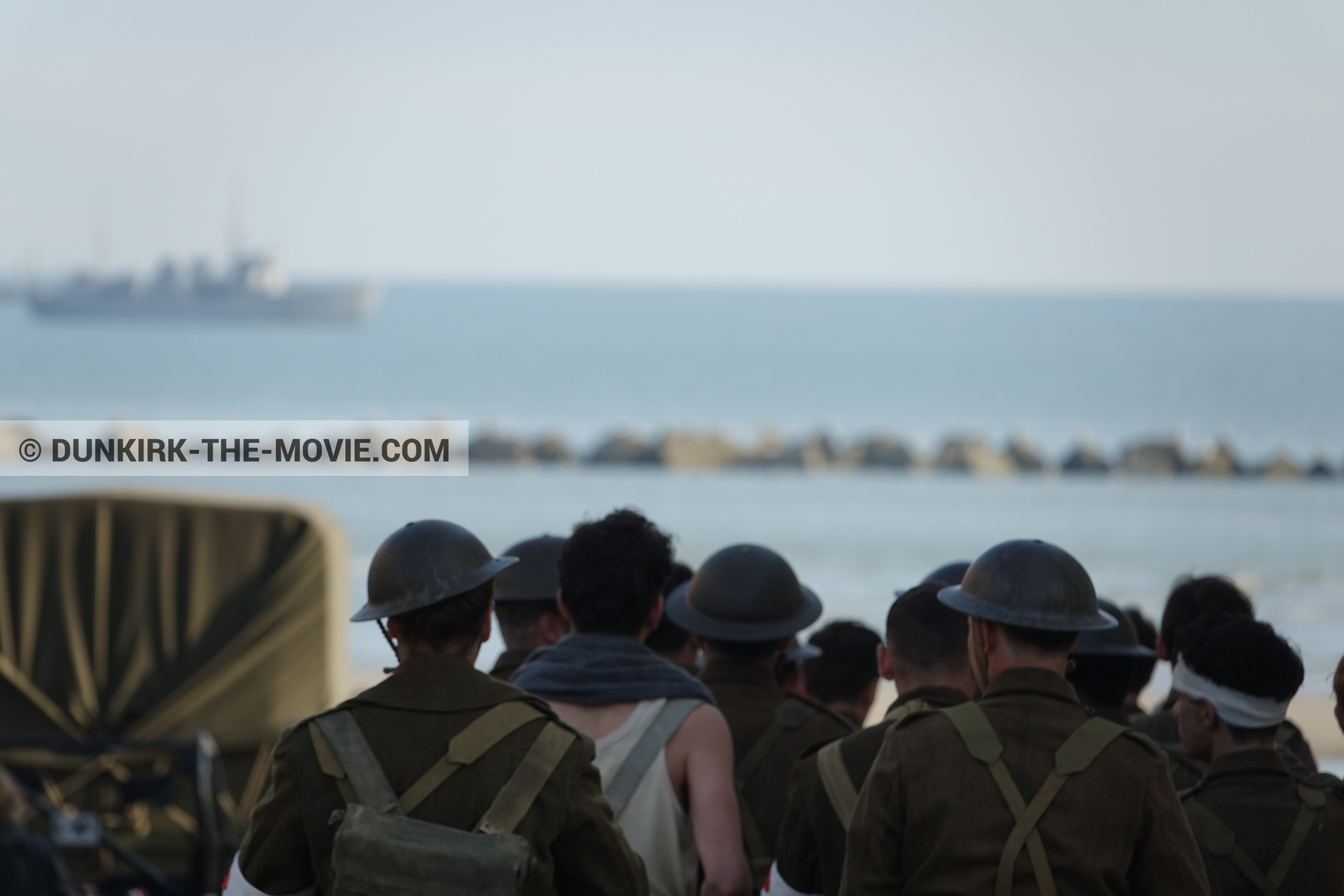 Picture with boat, truck, supernumeraries,  from behind the scene of the Dunkirk movie by Nolan
