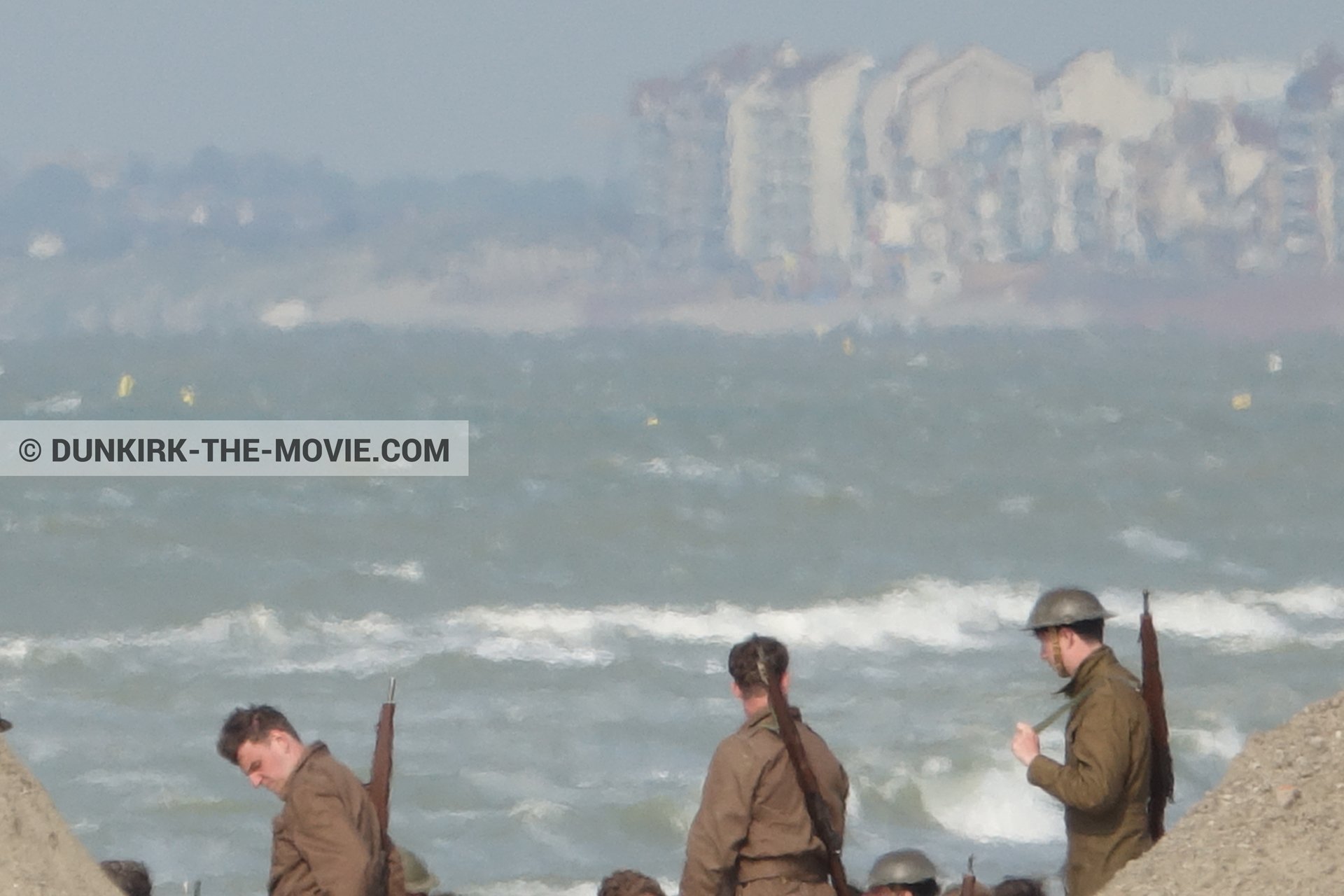 Picture with supernumeraries, rough sea, beach,  from behind the scene of the Dunkirk movie by Nolan