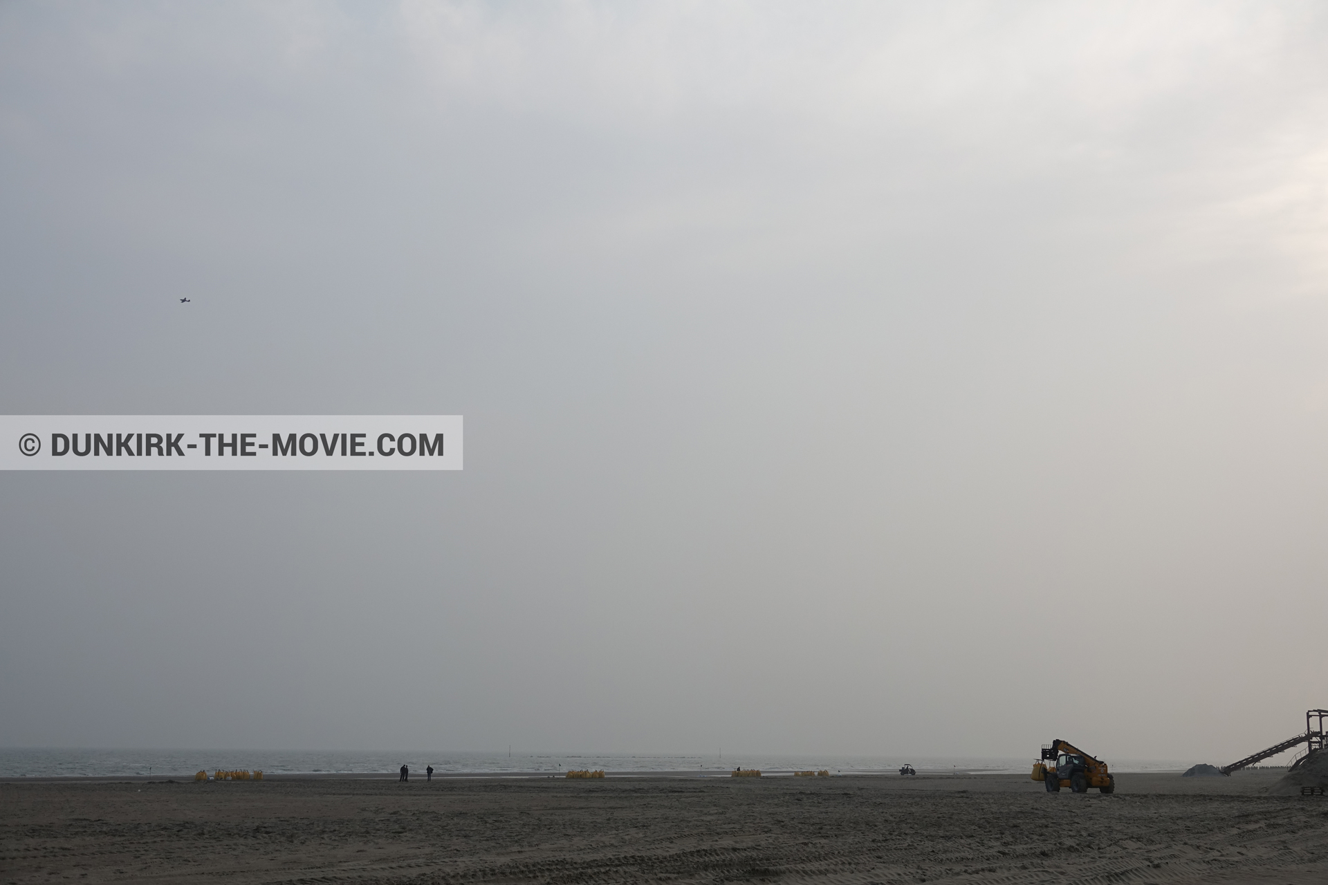 Picture with plane, grey sky, decor, beach,  from behind the scene of the Dunkirk movie by Nolan