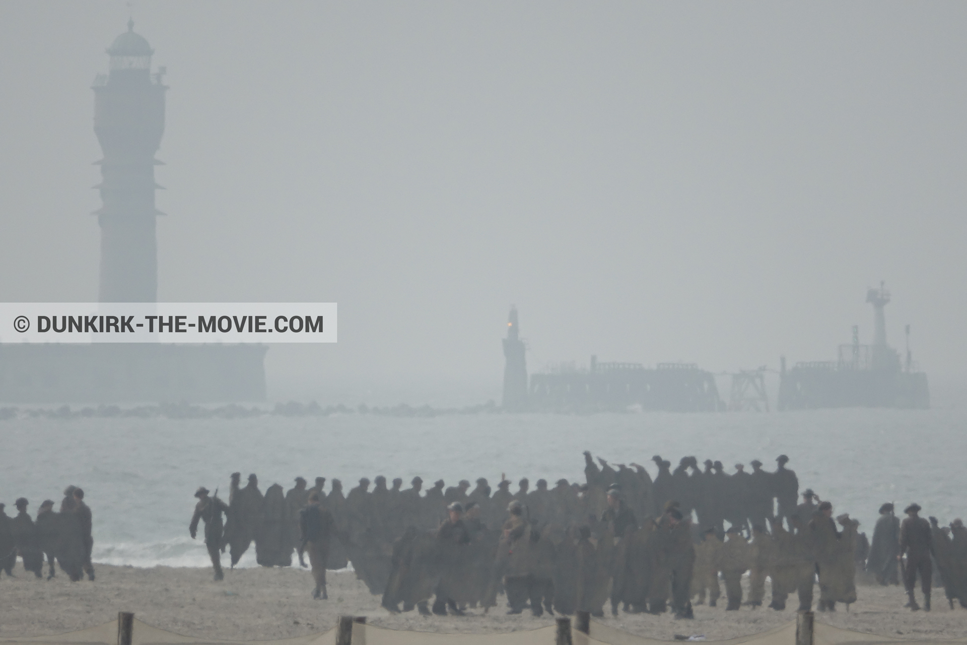 Picture with grey sky, supernumeraries, St Pol sur Mer lighthouse, beach,  from behind the scene of the Dunkirk movie by Nolan