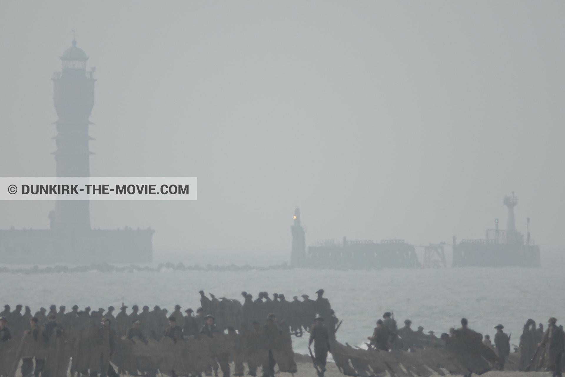 Picture with grey sky, supernumeraries, St Pol sur Mer lighthouse, beach,  from behind the scene of the Dunkirk movie by Nolan