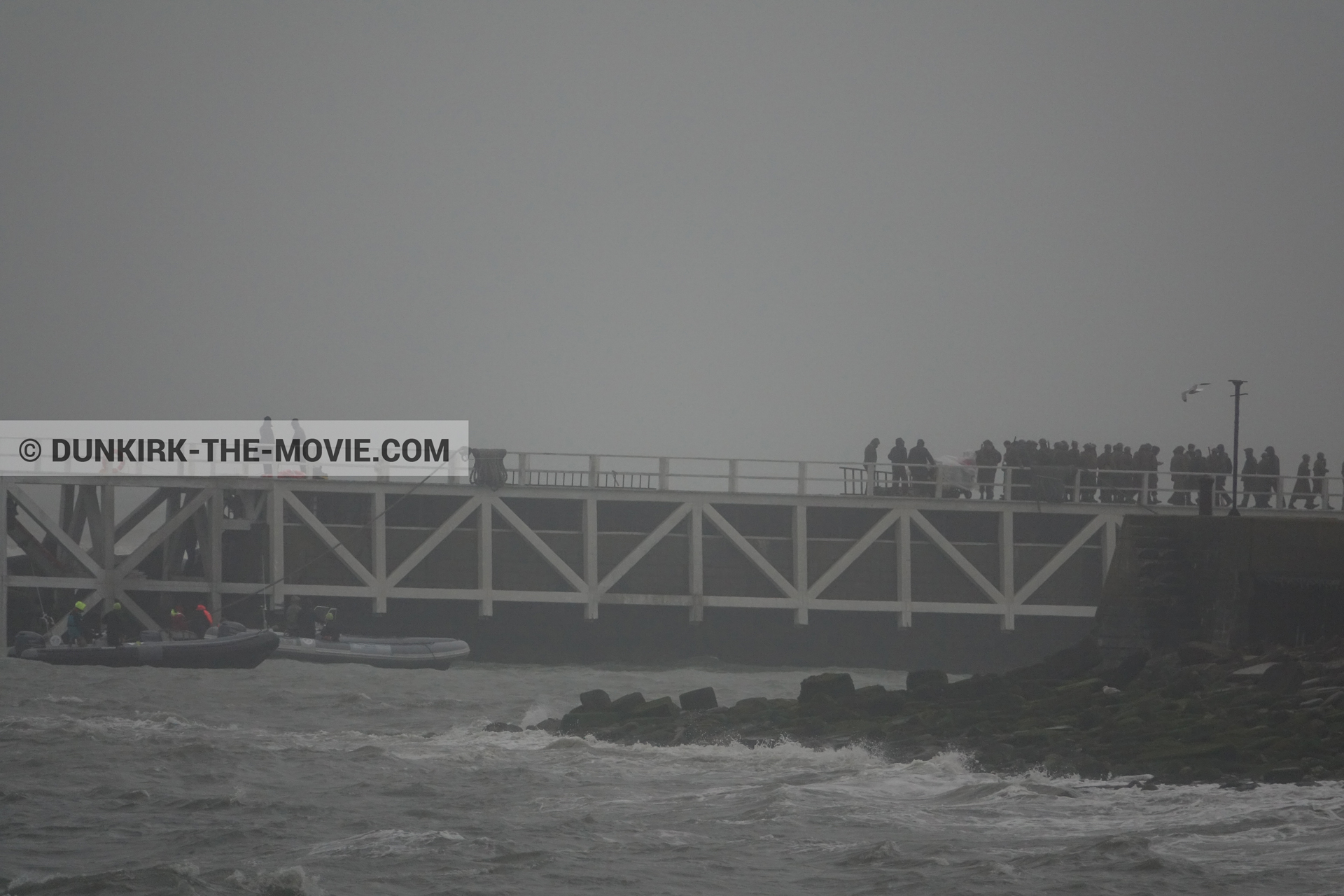 Picture with grey sky, supernumeraries, EST pier, rough sea,  from behind the scene of the Dunkirk movie by Nolan