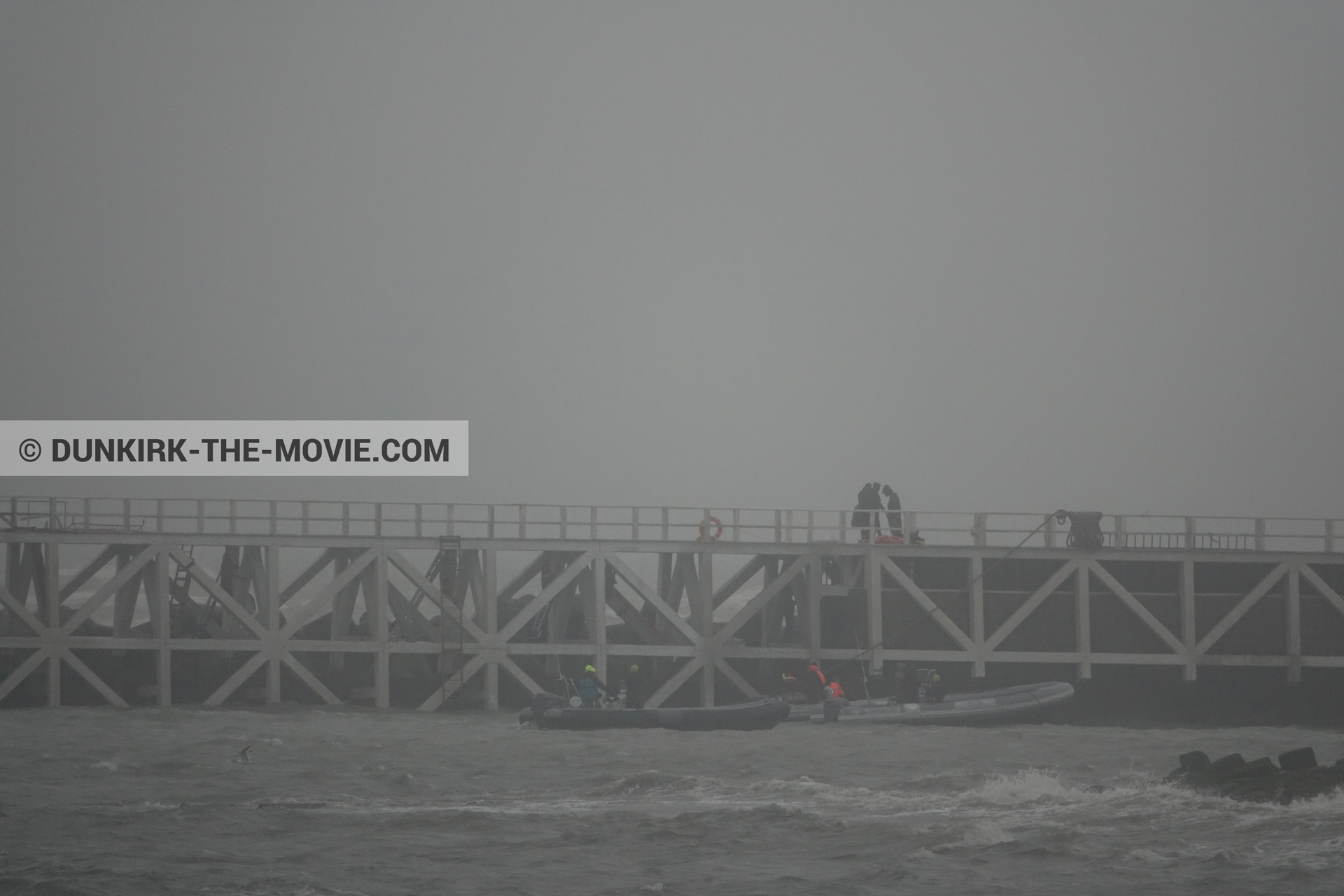 Picture with grey sky, EST pier, rough sea, inflatable dinghy,  from behind the scene of the Dunkirk movie by Nolan