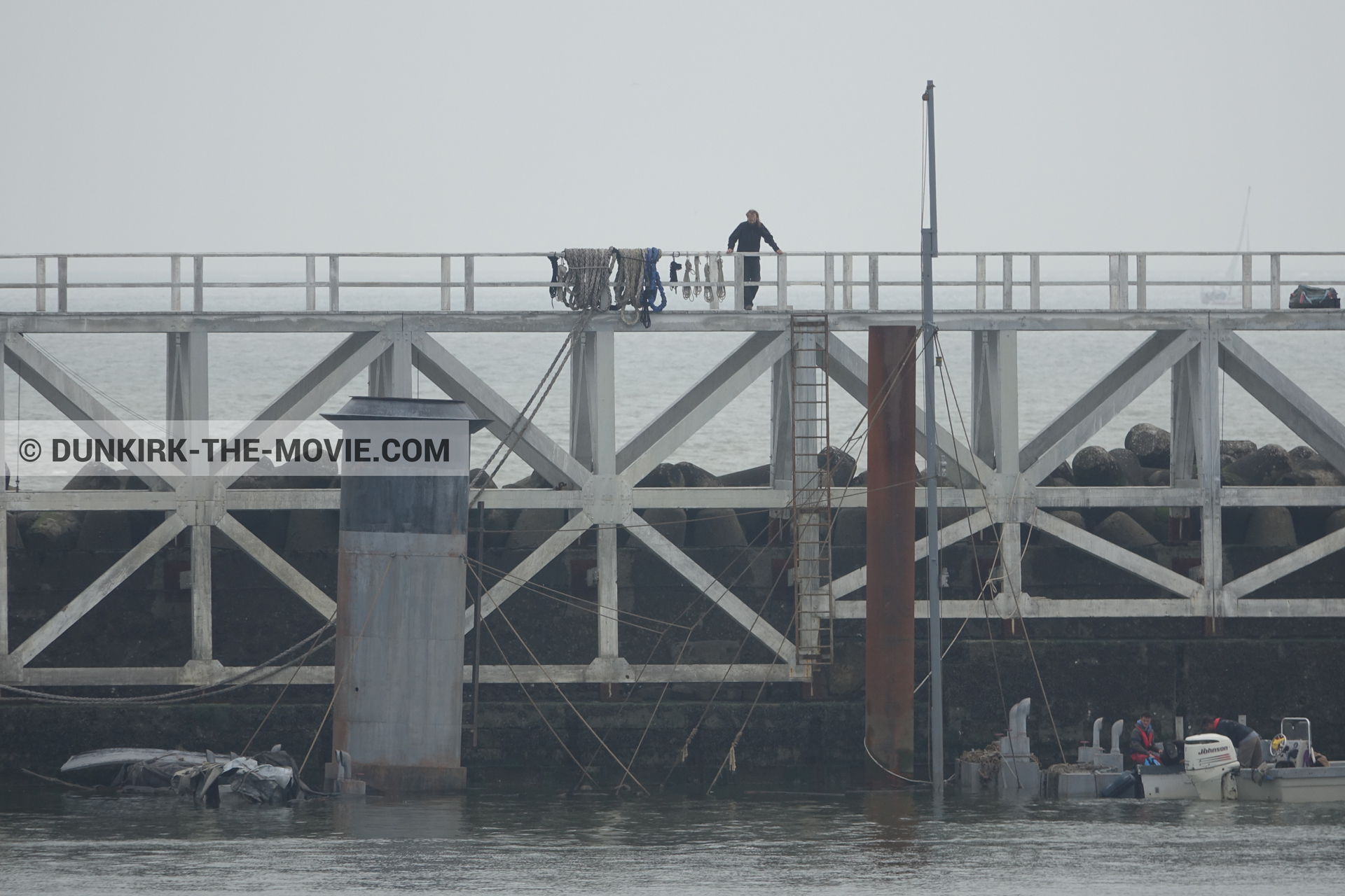 Picture with grey sky, decor, EST pier, calm sea,  from behind the scene of the Dunkirk movie by Nolan
