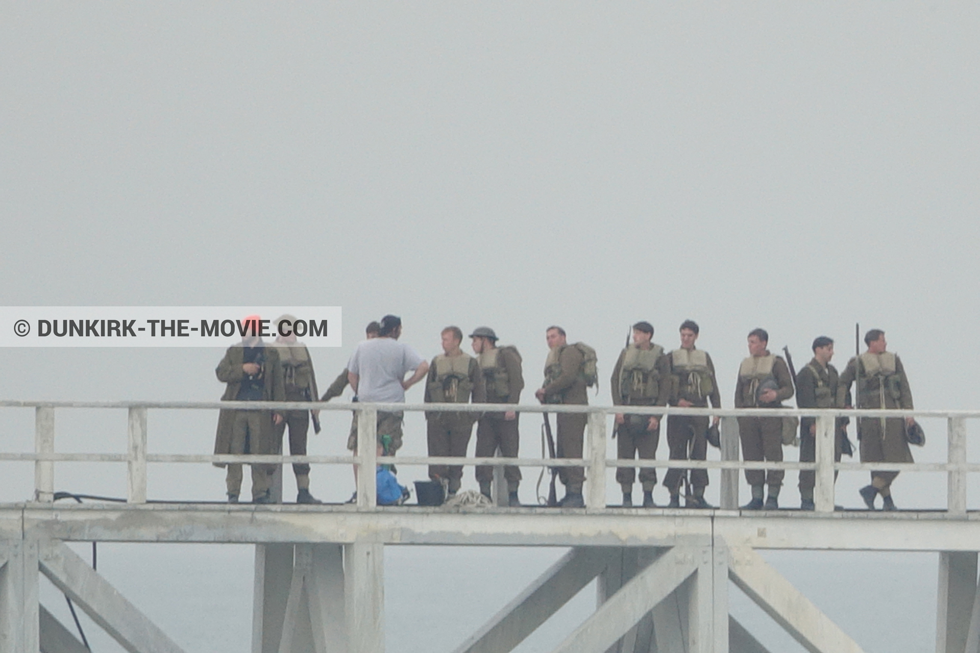 Picture with actor, grey sky, supernumeraries, EST pier, technical team,  from behind the scene of the Dunkirk movie by Nolan