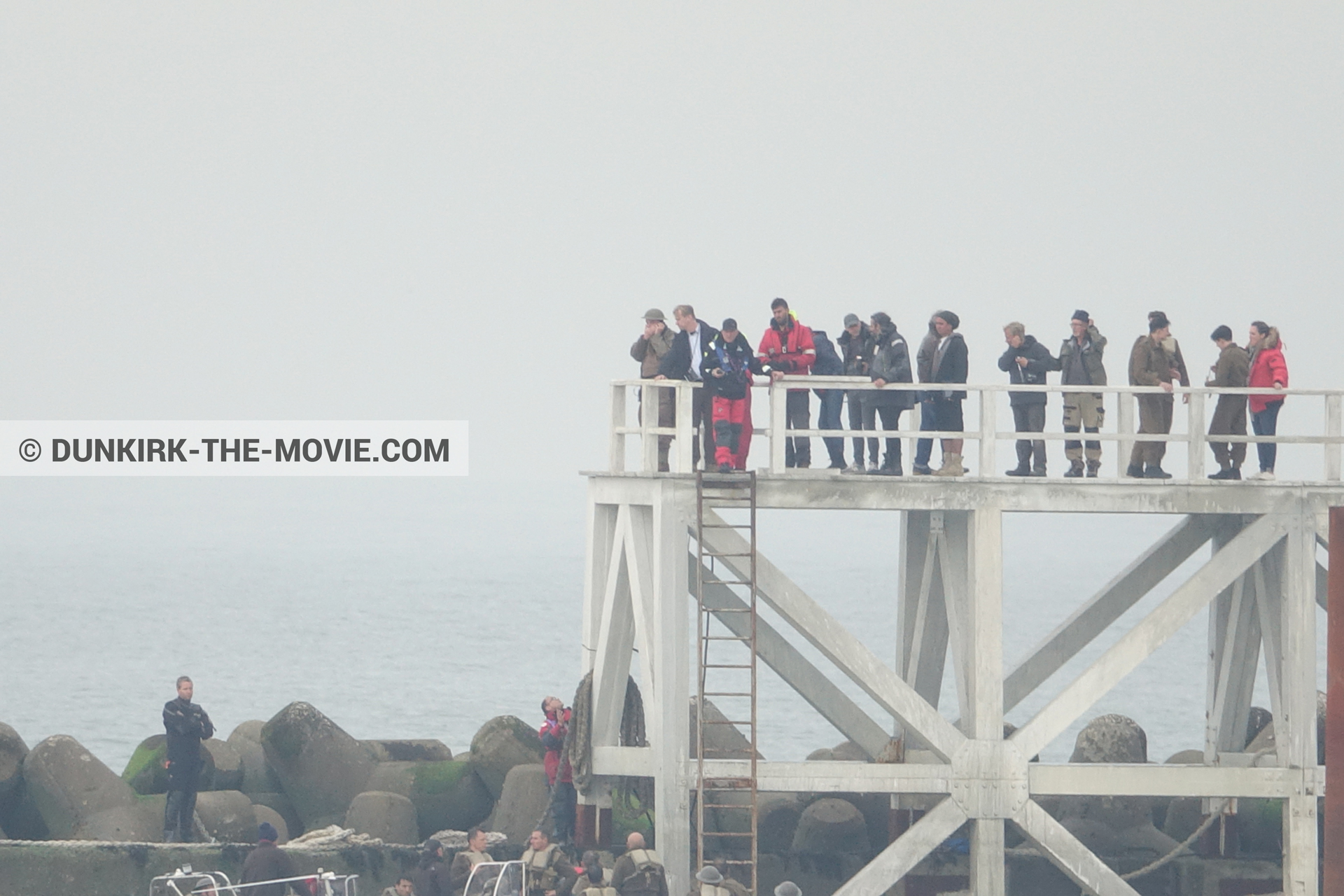 Picture with actor, grey sky, supernumeraries, Hoyte van Hoytema, EST pier, Christopher Nolan, inflatable dinghy,  from behind the scene of the Dunkirk movie by Nolan