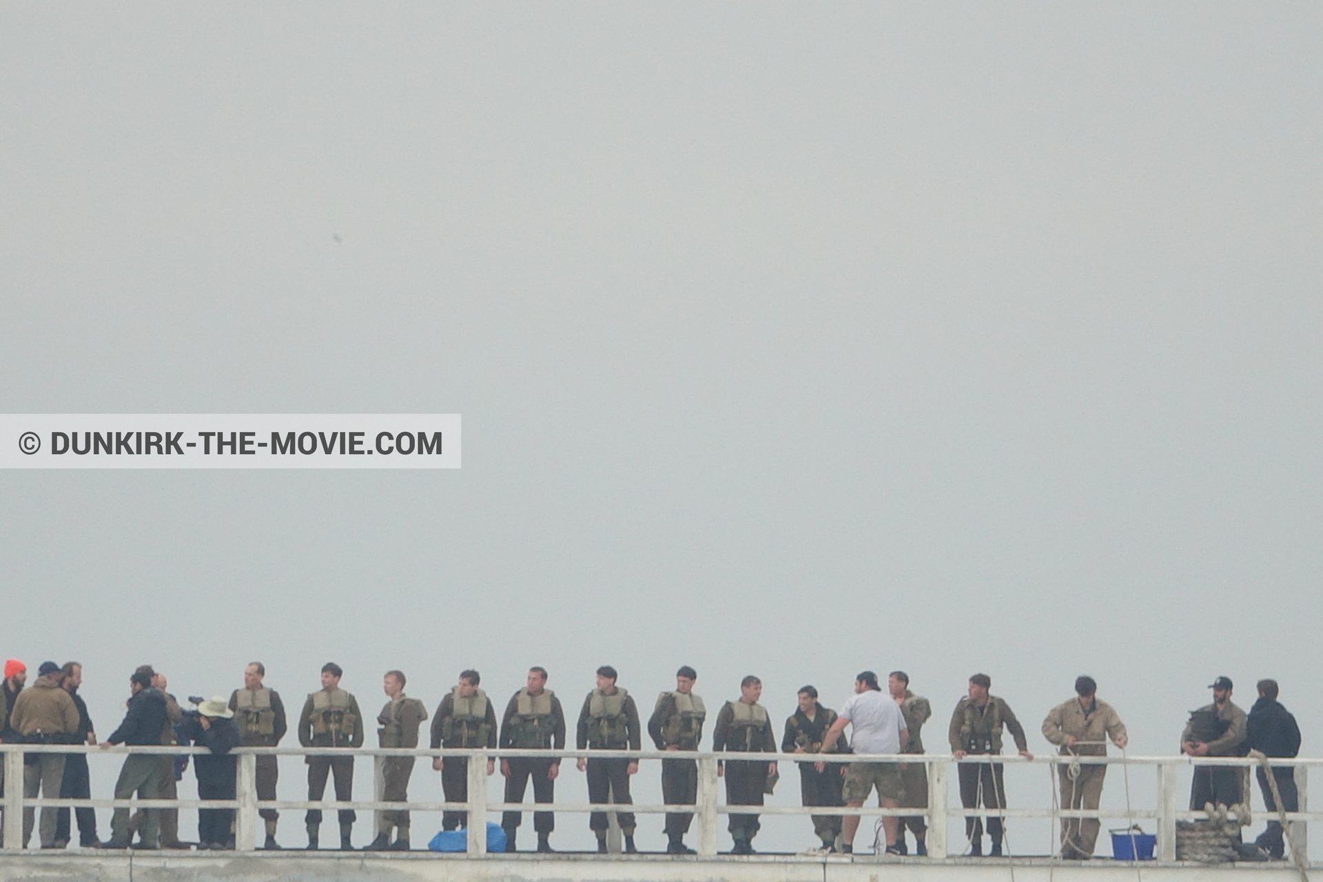 Picture with grey sky, supernumeraries, EST pier, technical team,  from behind the scene of the Dunkirk movie by Nolan