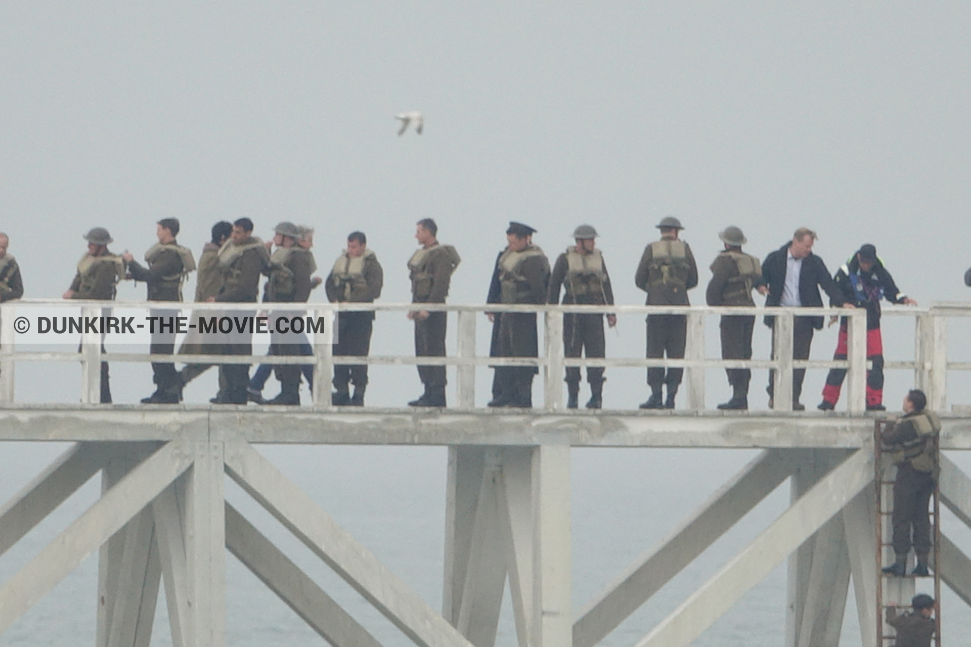 Picture with actor, grey sky, supernumeraries, EST pier, Christopher Nolan, technical team,  from behind the scene of the Dunkirk movie by Nolan
