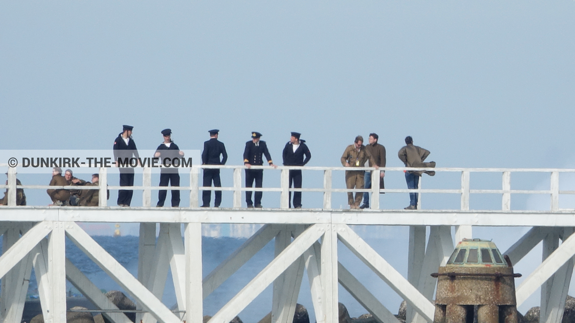 Picture with blue sky, supernumeraries, white smoke, EST pier, technical team,  from behind the scene of the Dunkirk movie by Nolan