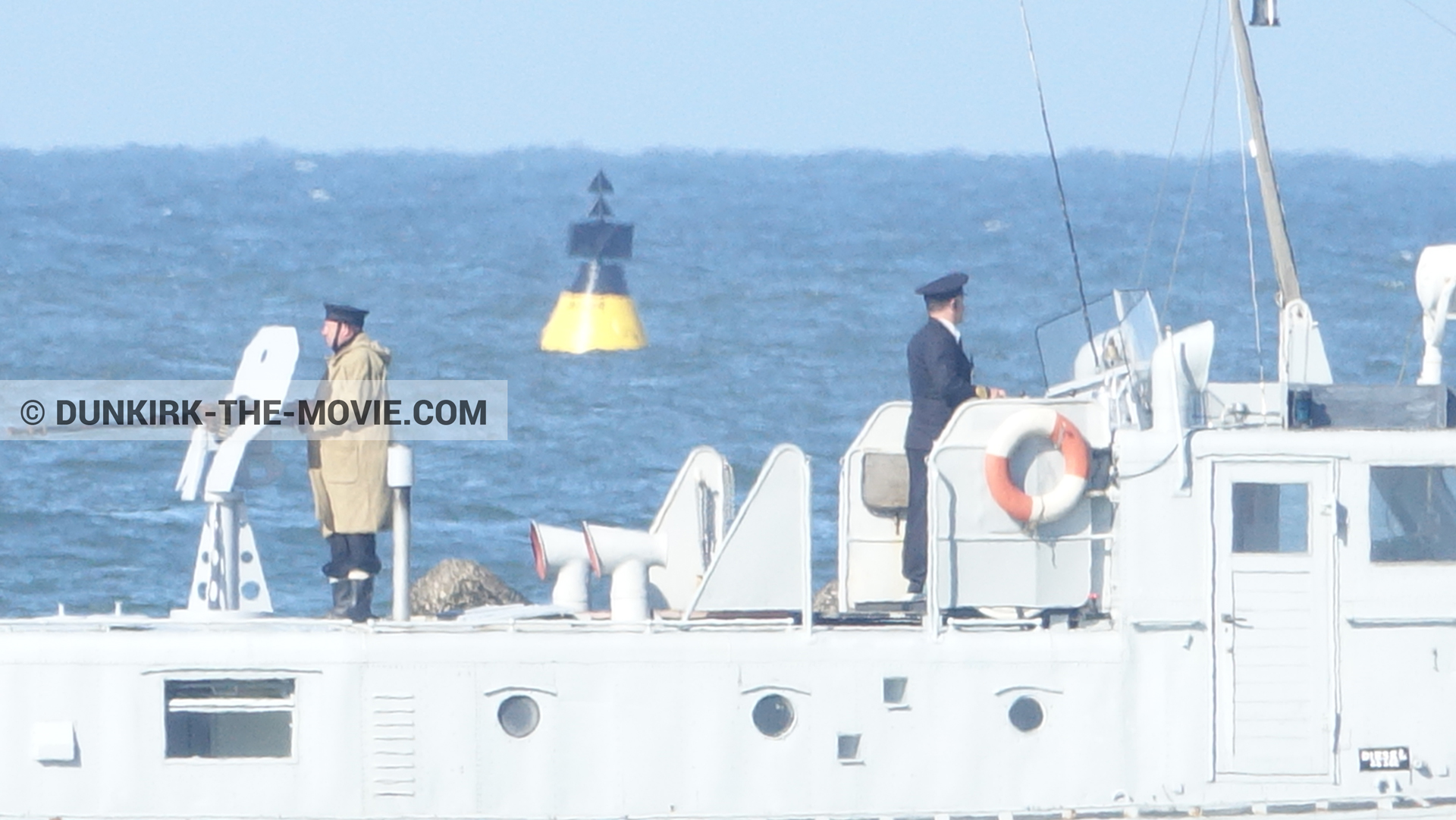 Picture with boat, blue sky, supernumeraries, calm sea, PR 22,  from behind the scene of the Dunkirk movie by Nolan