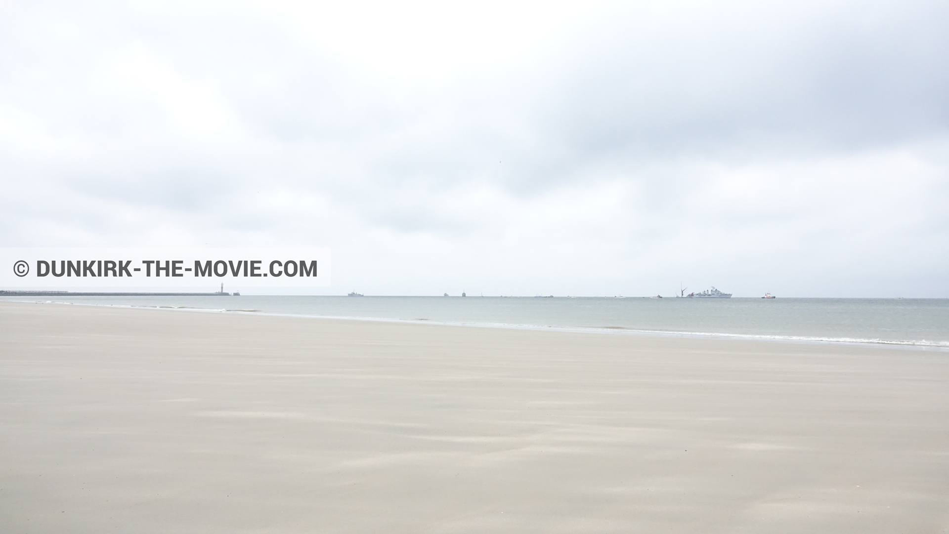 Picture with boat, cloudy sky, beach,  from behind the scene of the Dunkirk movie by Nolan