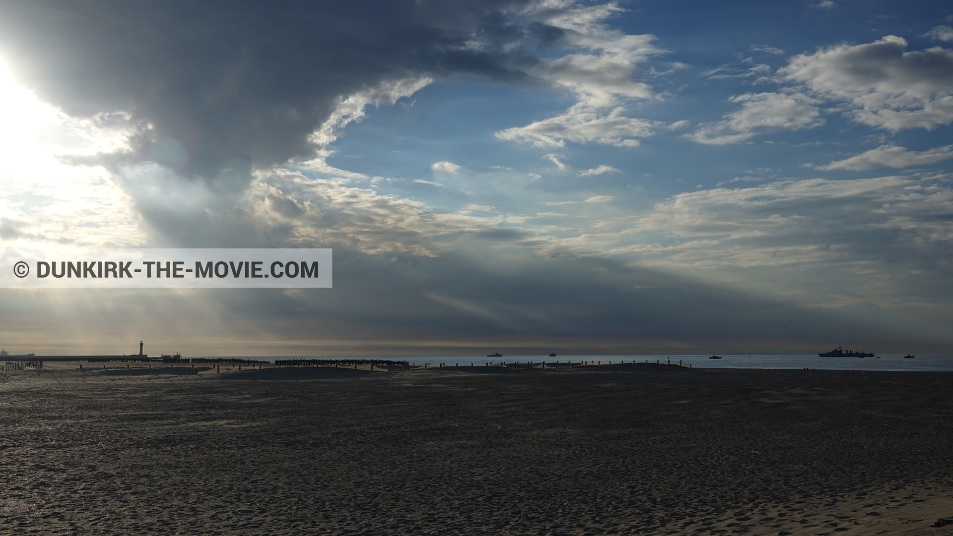Picture with boat, cloudy sky, St Pol sur Mer lighthouse, beach,  from behind the scene of the Dunkirk movie by Nolan