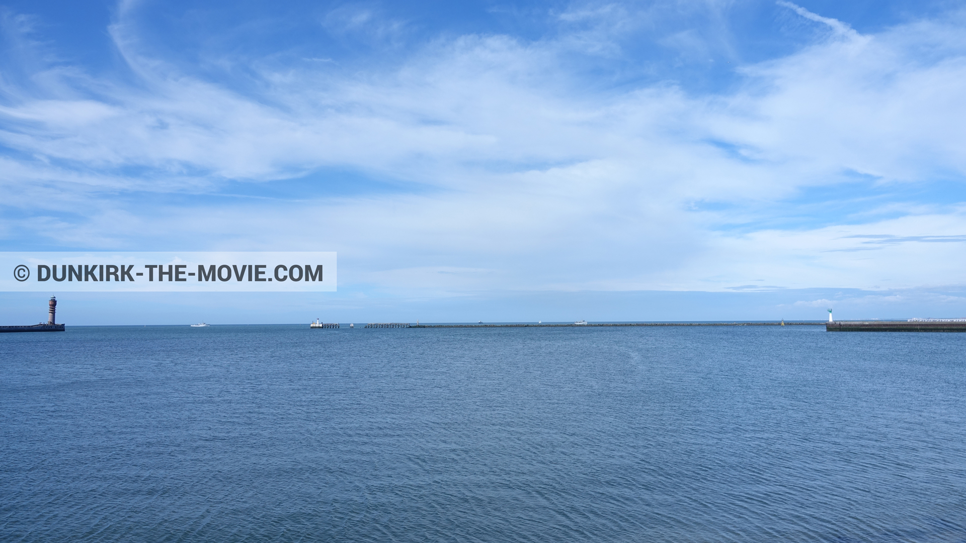 Picture with boat, cloudy sky, calm sea, St Pol sur Mer lighthouse,  from behind the scene of the Dunkirk movie by Nolan