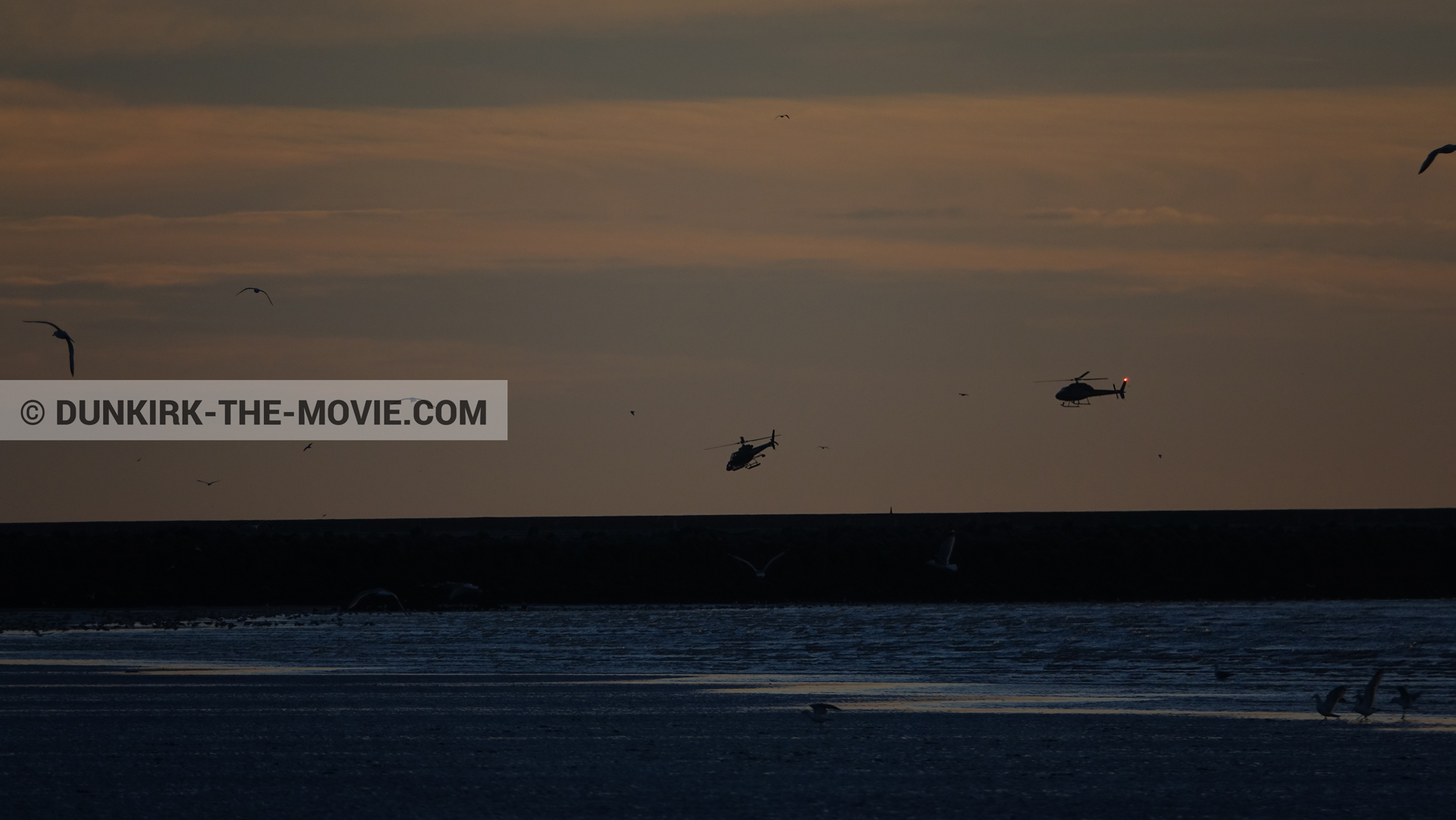 Picture with orange sky, helicopter camera,  from behind the scene of the Dunkirk movie by Nolan